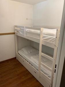 a white bunk bed in a small room at Au pied des pistes avec parking Entièrement rénové in LʼHuez