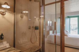 a bathroom with a shower with a glass door at Hidden Gabicce in Gabicce Mare