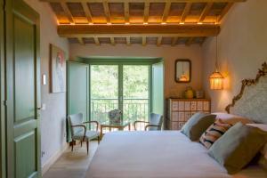 a bedroom with a bed and a table and a window at Hidden Gabicce in Gabicce Mare