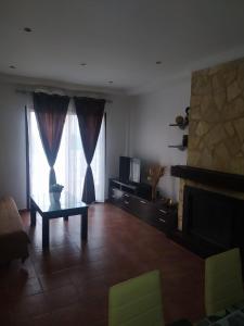 a living room with a table and a fireplace at Las Vistas in Arcos de la Frontera