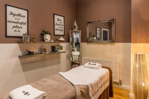 a room with a bed and a mirror at The Headland Hotel & Spa in Torquay