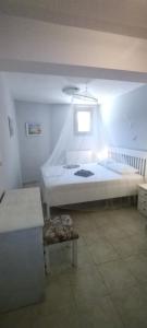 a bedroom with a large bed and a window at Christie's ground floor apartment by the sea in Kato Gatzea