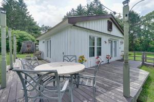 a table and chairs on a wooden deck with a building at Pet-Friendly Caneadea Retreat with Deck! in Oramel