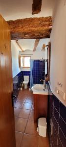 a bathroom with two toilets and a sink and a tub at Candela de la Murtera in Chelva