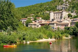 a group of people in kayaks on a river with a town at Maison Indépendante 3étoiles avec grand jardin in Saint-Germain
