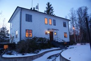 a large white house in the snow at night at Ankis Bed and Brekfast, Vimmerby in Vimmerby