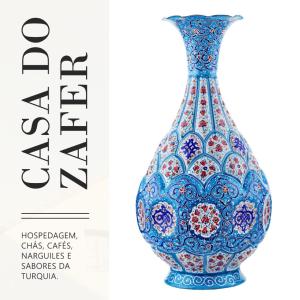 a blue glass vase with a pattern on it at Casa do Zafer in Sao Paulo