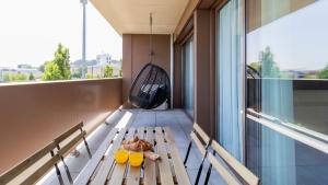 a balcony with a bench and a swing at Modern and Spacious 1BR in Gaia by LovelyStay in Vila Nova de Gaia