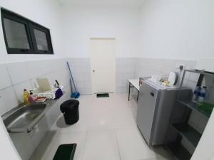 a white kitchen with a sink and a refrigerator at T STAY at Icon Residence -for 1 Room Free Netflix & Pool in Kuala Terengganu