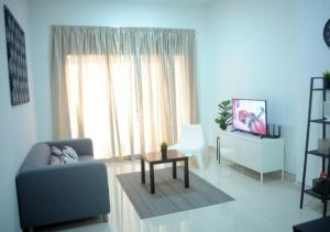 a living room with a couch and a table at T STAY at Icon Residence -for 1 Room Free Netflix & Pool in Kuala Terengganu