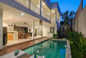 a house with a swimming pool in a yard at Selog Villa 4 in Seminyak