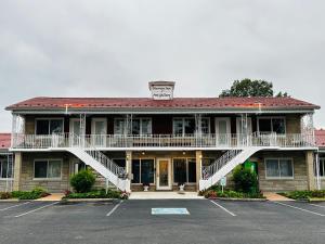 a large building with a staircase in a parking lot at Murray Inn and Art Gallery in Murray