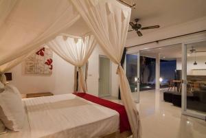 a bedroom with a bed and a living room at Selog Villa 4 in Seminyak +27 photos