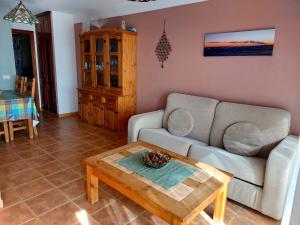 a living room with a couch and a coffee table at Alma y Sol in La Caleta