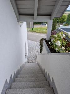 a stairway leading up to a building with flowers at Ferienwohnung -Time to relax- bei Bamberg, mit herrlichem Blick auf das Maintal in Viereth-Trunstadt