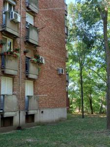 a brick building with balconies on the side of it at Apartman Lola Ruža in Zrenjanin