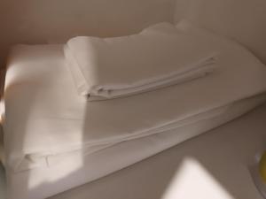 a stack of white towels sitting on top of a counter at Appartement T2 avec balcon à Argelès Gazost in Argelès-Gazost