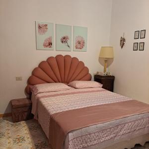 a bedroom with a large bed with a large headboard at La Caletta Praiano Smart working in totale relax immersi nella natura incontaminata in Praiano