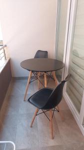 a table and two chairs sitting next to a window at Luxury Apartment Nika in Ohrid