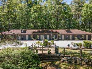 a large house with a fence and a yard at Hotel Cashiers in Cashiers