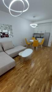 a living room with a couch and a table and chairs at Luxury Apartment Nika in Ohrid