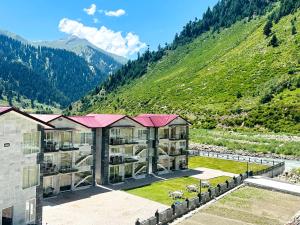 an aerial view of a building with a mountain at Kunhar Hotel RiverSide Block in Naran