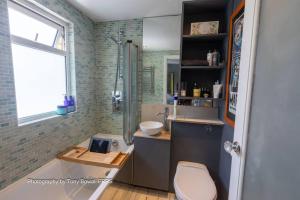 a bathroom with a toilet and a sink and a shower at Hove Art Deco Spacious House in Brighton & Hove