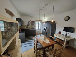 a kitchen with a table and a dining room at Casa Etrusca in Città di Castello