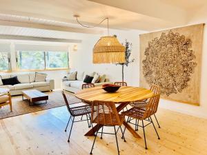 a living room with a wooden table and chairs at Salema Eco Camp - Sustainable Camping & Glamping in Salema