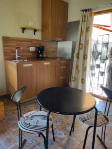 a kitchen with a table and two chairs and a table at Pension Gabino (rooms) in El Ganso