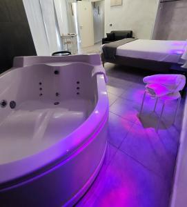 a bathroom with a tub with purple lights in it at Living in Casoria