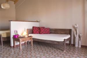 a living room with a couch and a table at Pension Gabino (rooms) in El Ganso