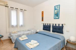 a bedroom with two beds with towels on them at My Opera Private Pool by Sarda Bella in Rudalza +27 photos