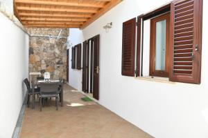 a dining room with a table and a window at My Opera Private Pool by Sarda Bella in Rudalza