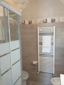 a bathroom with a toilet and a towel rack at LUCIA HOME CASA VACANZE in Santa Maria del Molise