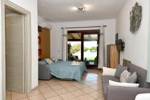 a living room with a bed and a couch at My Opera Private Pool by Sarda Bella in Rudalza