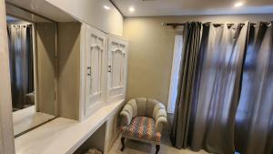 a bathroom with a sink and a mirror and a chair at Green orchard skardu in Skardu +46 photos