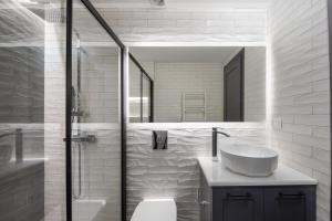 a white bathroom with a sink and a mirror at Modern-Vintage Old Town Suites in Corfu Town +27 photos