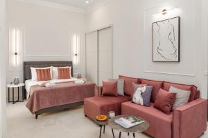 a living room with a bed and a couch at Modern-Vintage Old Town Suites in Corfu Town