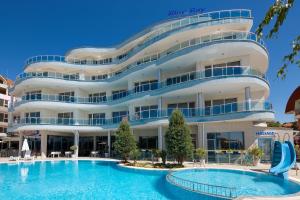 a hotel with a swimming pool in front of a building at Blue Bay Hotel in Sunny Beach