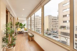 an apartment balcony with large windows and plants at Apartamento Girassol - Minho's Guest in Braga