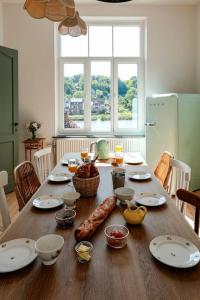 a wooden table with food on top of it at La Maison du Rivage in Dinant