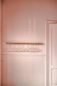 a white refrigerator with a shelf on the wall at La Maison du Rivage in Dinant