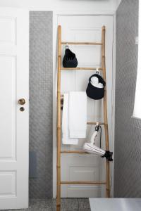 a towel rack in a bathroom with towels at Fradelos Porto Centro in Porto