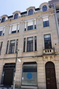 a large stone building with a blue logo on it at Fradelos Porto Centro in Porto