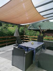 a patio with a table and chairs under a large umbrella at Enjoy the silence in Rezi