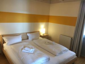a large bed with two white pillows on it at Ferienhaus Müritzhus an der Müritz in Marienfelde