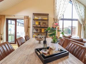 a living room with a wooden table and chairs at 256 London Road in Colchester