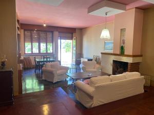 a living room with white furniture and a fireplace at Vista Mare a 300 mt dalla spiaggia in Cariati