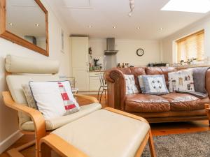 a living room with two couches and a couch at Godrevy Barn in Hayle